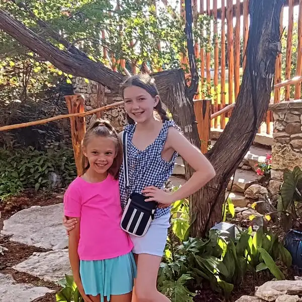 Blair and Brooke on a stone path under a tree